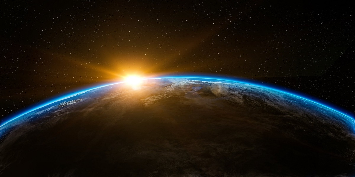 A stunning view of the sun rising over Earth’s horizon seen from outer space.